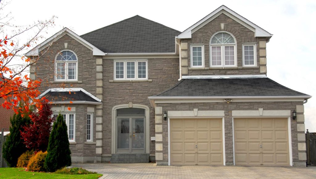 Stunning Colorado two-story house showcasing classic brick exterior, large windows, double garage, and manicured lawn, perfect for luxury residential living and real estate investment.